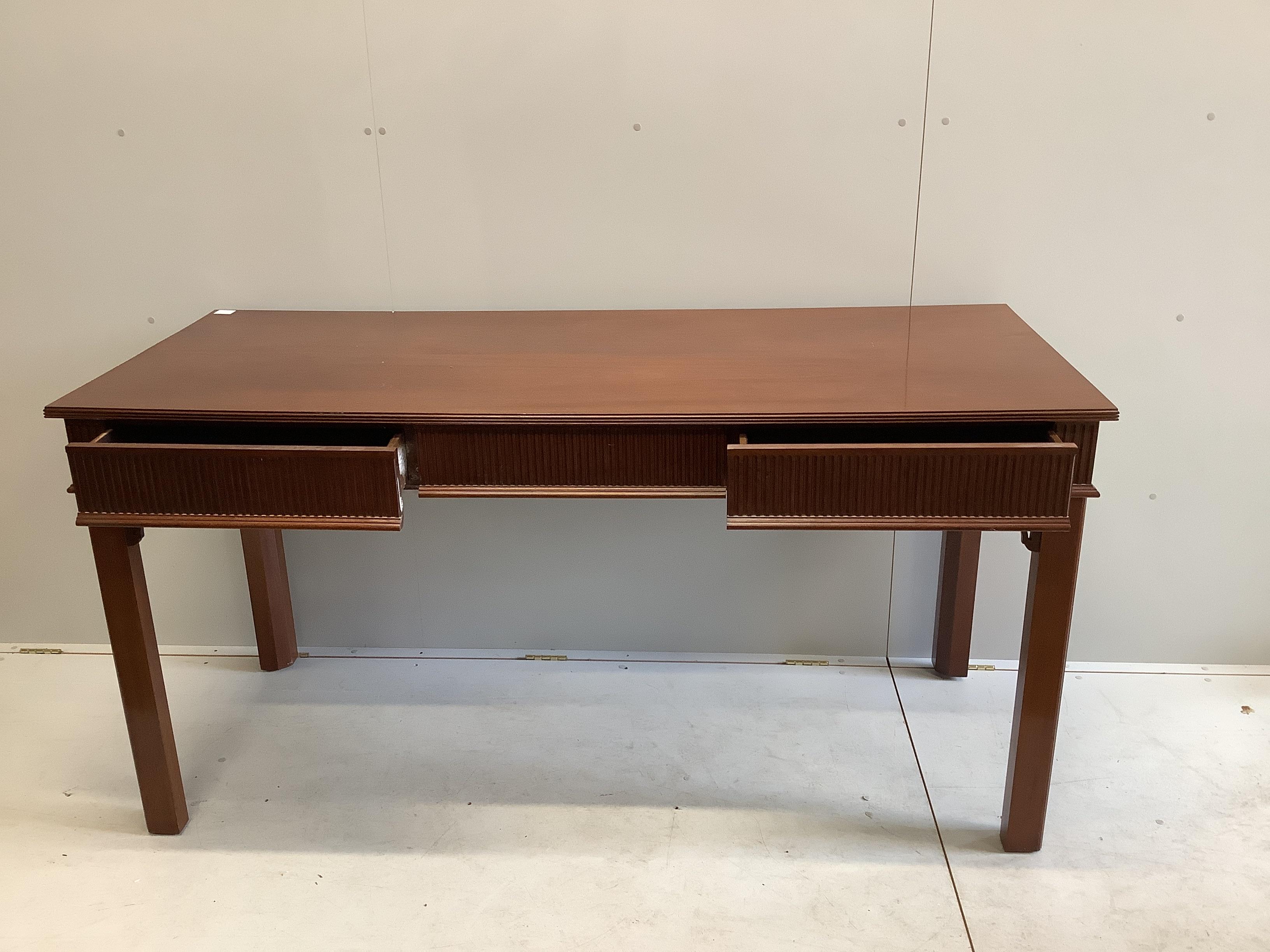 A George III style mahogany serving table, fitted three frieze drawers, the back incorporating two secret drawers, width 183cm, depth 76cm, height 92cm